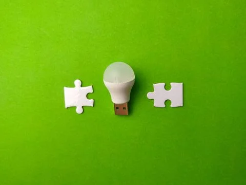 A conceptual high-angle studio shot featuring a white USB LED light bulb pl.. 写真素材