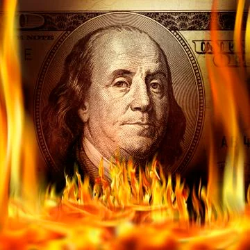 Conceptual image of burning dollar bill and fire flames Stock Photos