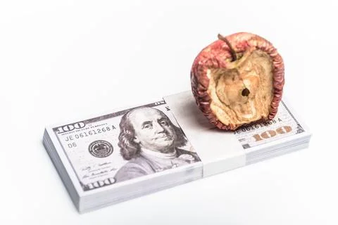 A conceptual image centered on a bad apple, money for various monetary ideas. Stock Photos