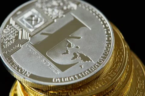 Conceptual image of crypto currency with isolated bitcoins on dark table. Focus Stock Photos