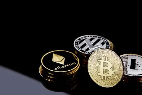 Conceptual image of different cryptocurrency with bitcoins on dark table, close Stock Photos