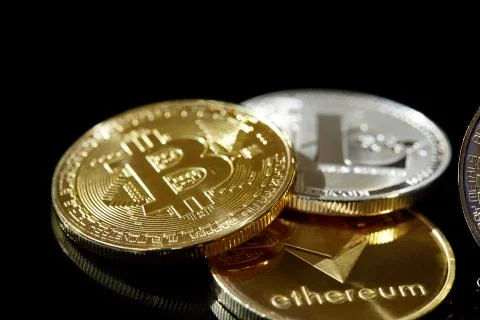 Conceptual image of different cryptocurrency with bitcoins on dark table, close Stock Photos