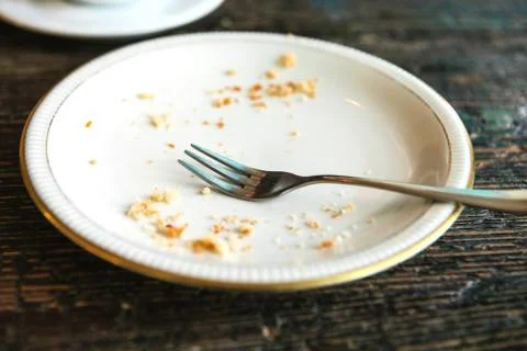 Conceptual image of the end of the holiday is an empty plate with crumbs and a Stock Photos