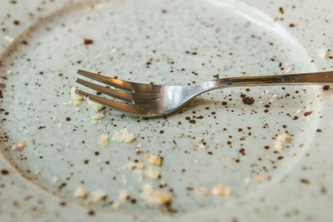 Conceptual image of the end of the holiday is an empty plate with crumbs and a Stock Photos