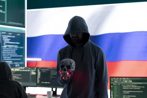Conceptual image of a hooded russian hacker creating hazardous alerts Stock Photos