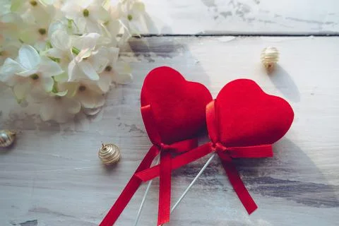 Conceptual image of love with two red velvet hearts and hydrangea  flowers an Stock Photos