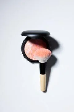 Conceptual image of makeup blusher and brush. Stock Photos