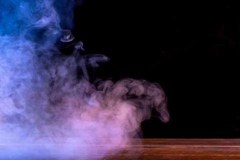 Conceptual image of multi-colored smoke isolated on dark black background a.. Stock Illustration