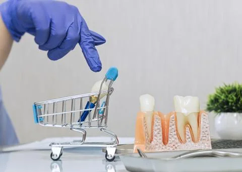 Conceptual image of purchasing dental services. Doctor pointing to tooth impl Stock Photos