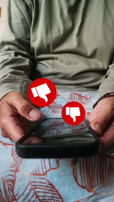 Conceptual image of thumbs down icons floating above a smartphone screen Stock Footage 341579668