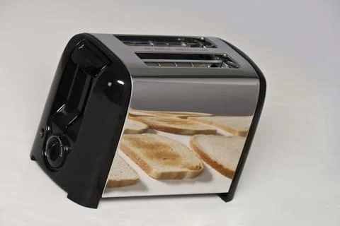 Conceptual image of toaster with bread Stock Photos