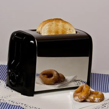 Conceptual image of toaster with bread Stock Photos
