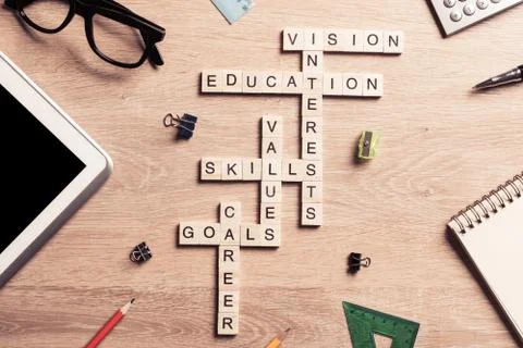 Conceptual keywords on wooden table with elements of game making crossword 스톡 사진