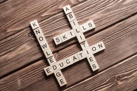 Conceptual keywords on wooden table with elements of game making crossword Stock Photos