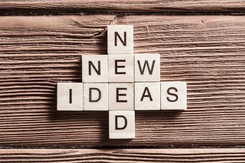 Conceptual keywords on wooden table with elements of game making crossword 스톡 사진