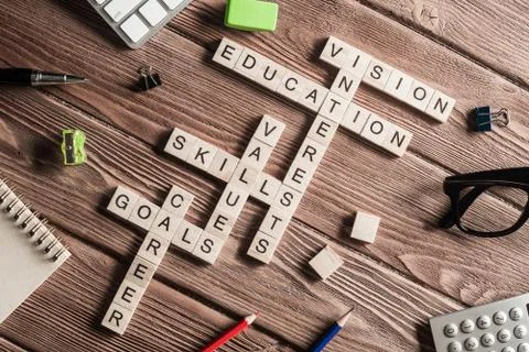 Conceptual keywords on wooden table with elements of game making crossword Stock Photos