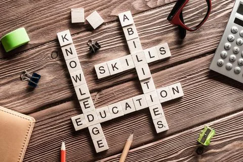 Conceptual keywords on wooden table with elements of game making crossword Stock Photos