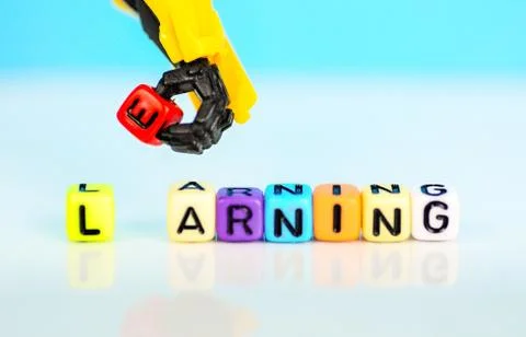 Conceptual machine learning. Robotic hand represents machine holding red bead 스톡 사진