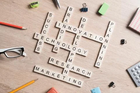 Conceptual media keywords on table with elements of game making crossword Stock Photos