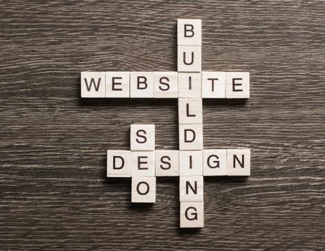 Conceptual media keywords on table with elements of game making crossword Foto stock