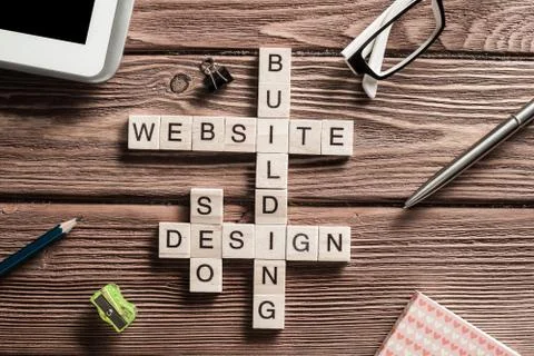 Conceptual media keywords on table with elements of game making crossword Foto stock