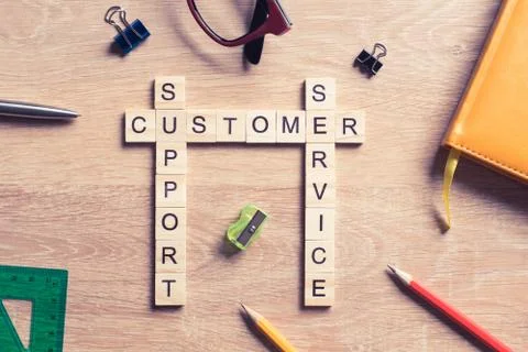 Conceptual media keywords on table with elements of game making crossword Stock Photos