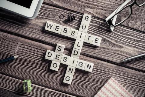 Conceptual media keywords on table with elements of game making crossword Foto stock