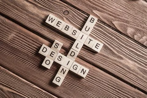 Conceptual media keywords on table with elements of game making crossword Foto stock