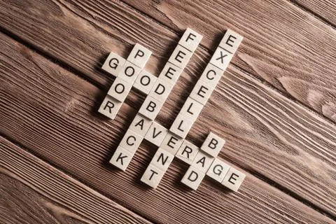 Conceptual media keywords on table with elements of game making crossword Stock Photos