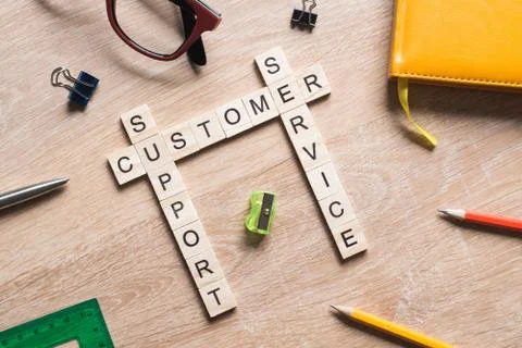 Conceptual media keywords on table with elements of game making crossword Foto stock