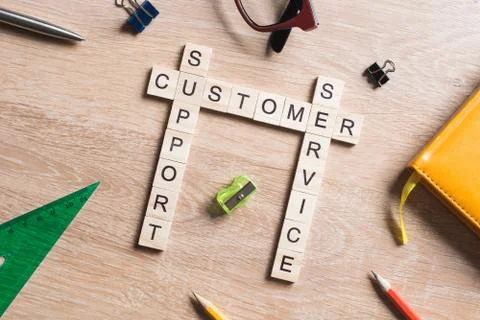 Conceptual media keywords on table with elements of game making crossword Stock Photos