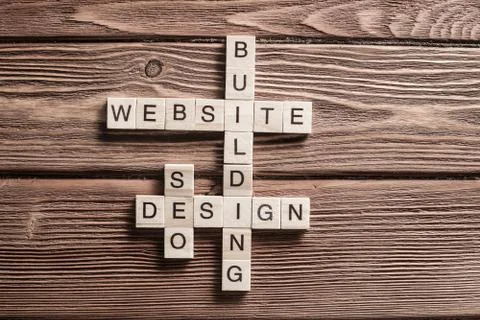 Conceptual media keywords on table with elements of game making crossword Stock Photos