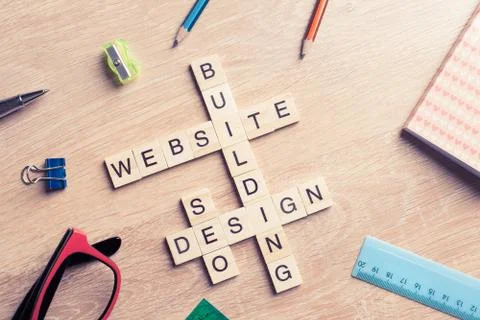 Conceptual media keywords on table with elements of game making Stock Photos