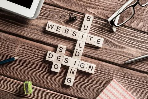 Conceptual media keywords on table with elements of game making crossword Foto stock