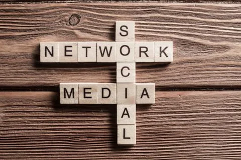 Conceptual media keywords on table with elements of game making crossword Foto stock