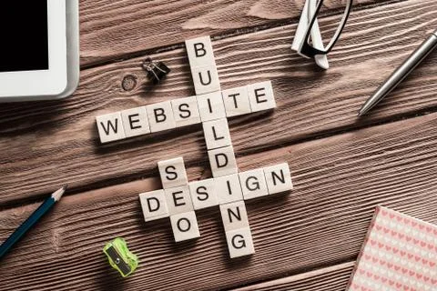 Conceptual media keywords on table with elements of game making crossword Stock Photos