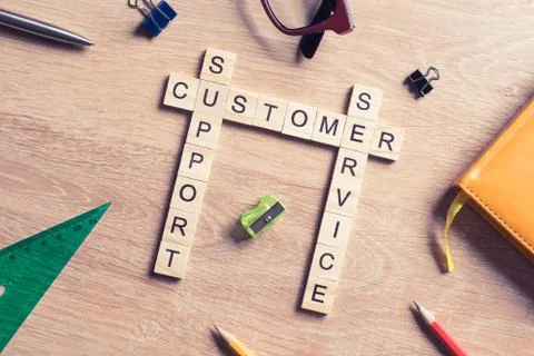 Conceptual media keywords on table with elements of game making crossword Stock Photos