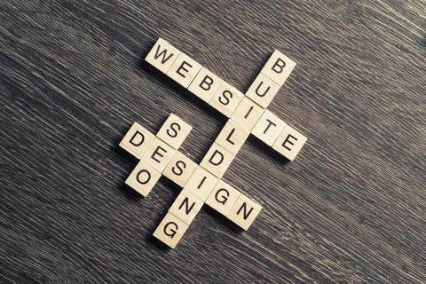 Conceptual media keywords on table with elements of game making crossword Foto stock