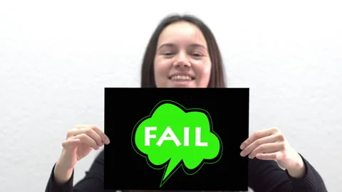 Conceptual message "Fail" on canvas frame label hold by beautiful girl smilin Stock Footage 142338648