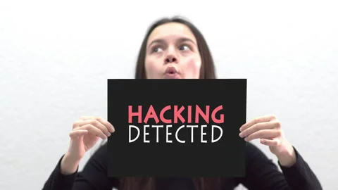 Conceptual message "Hacking Detected" on canvas frame label hold by beautiful Stock Footage 146997440