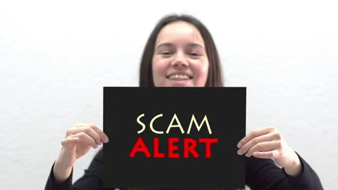 Conceptual message "Scam Alert" on canvas frame label hold by beautiful girl Stock Footage 150064142