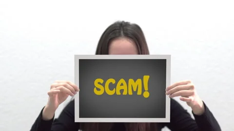 Conceptual message "Scam" on canvas frame label hold by beautiful girl smilin Stock Footage 162610951