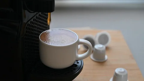 Conceptual modern coffee machine at home, on the table and a cup of fresh aromat Stock Footage 130044713