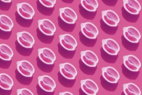 Conceptual pattern with halves of lemon with shadow on purple background. Foto stock