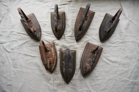 Conceptual photography - a set of antique cast iron irons on the surface of a Stock Photos