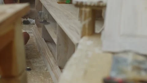 Conceptual plan, focus and out of focus, working atmosphere, a carpenter squats Stockbeeldmateriaal 257404924