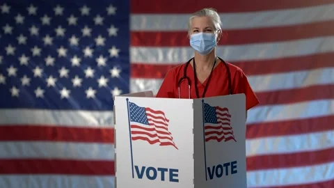 Conceptual portrait US flag background with smiling woman nurse in face mask Video stock 139636415