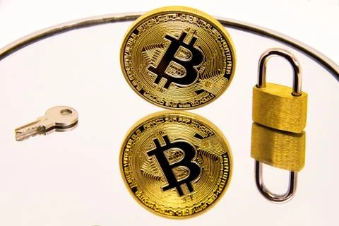 Conceptual representation of the safety or security of bitcoin on a white mir Stock Photos