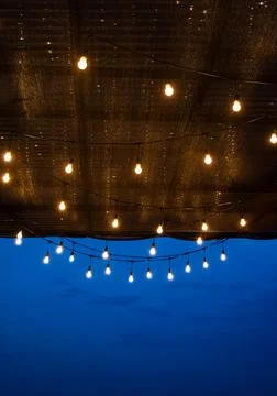 Conceptual romantic background of a cafe's ceiling with a lot of hanging li.. Stock Photos