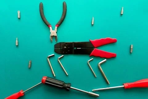 Conceptual set of tools on green background. It looks like a deer. Working ha Stock Photos